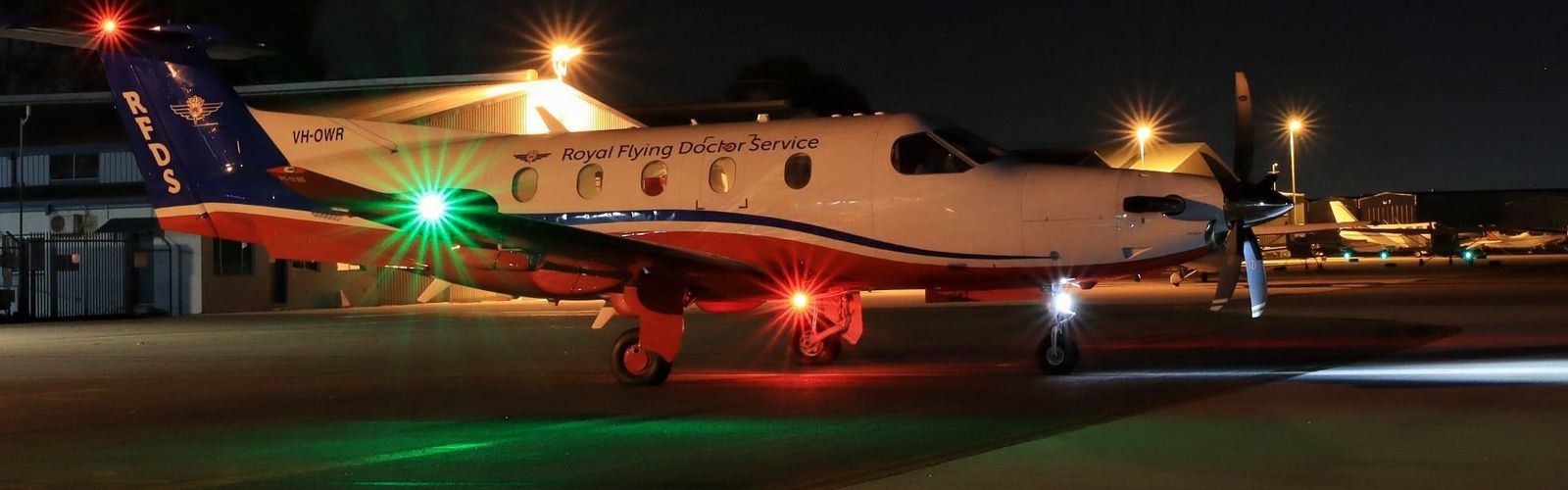 RFDS WA PC-12 plane with green and red christmas lights on tarmac