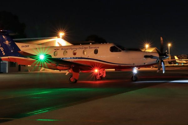 RFDS WA PC-12 plane with green and red christmas lights on tarmac