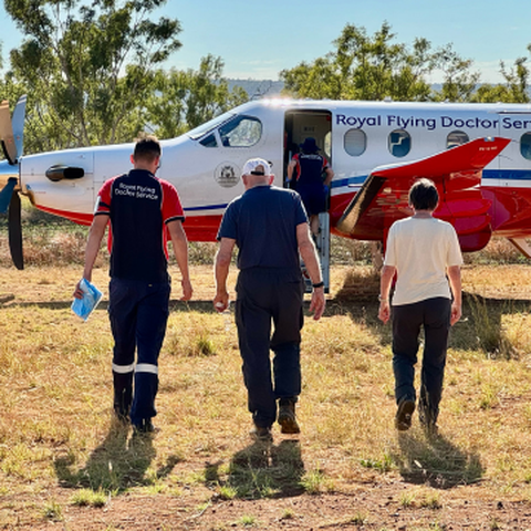 Doctor and patients walking to plane