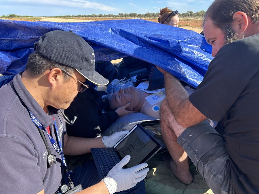 Dr Bai helping patient 