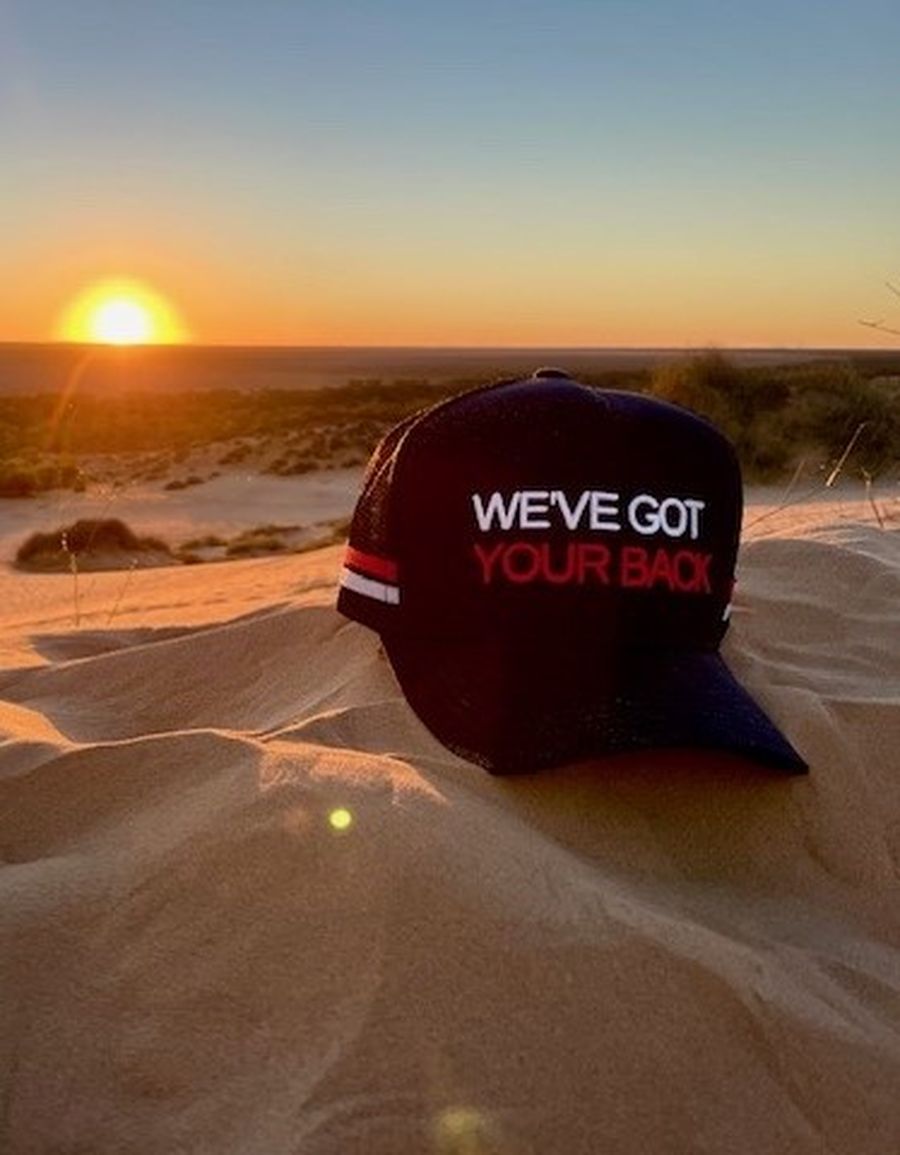 A We've Got your Back cap pictured against a sunrise