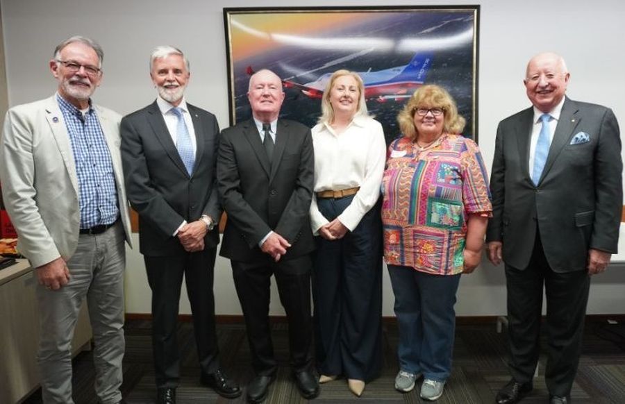 Life Members standing with CEO Judith Barker and Board Chair Sam Walsh.