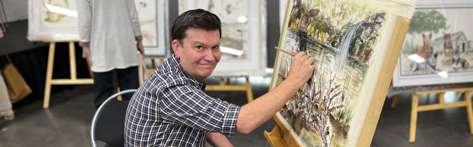 Stuart painting a donated painting